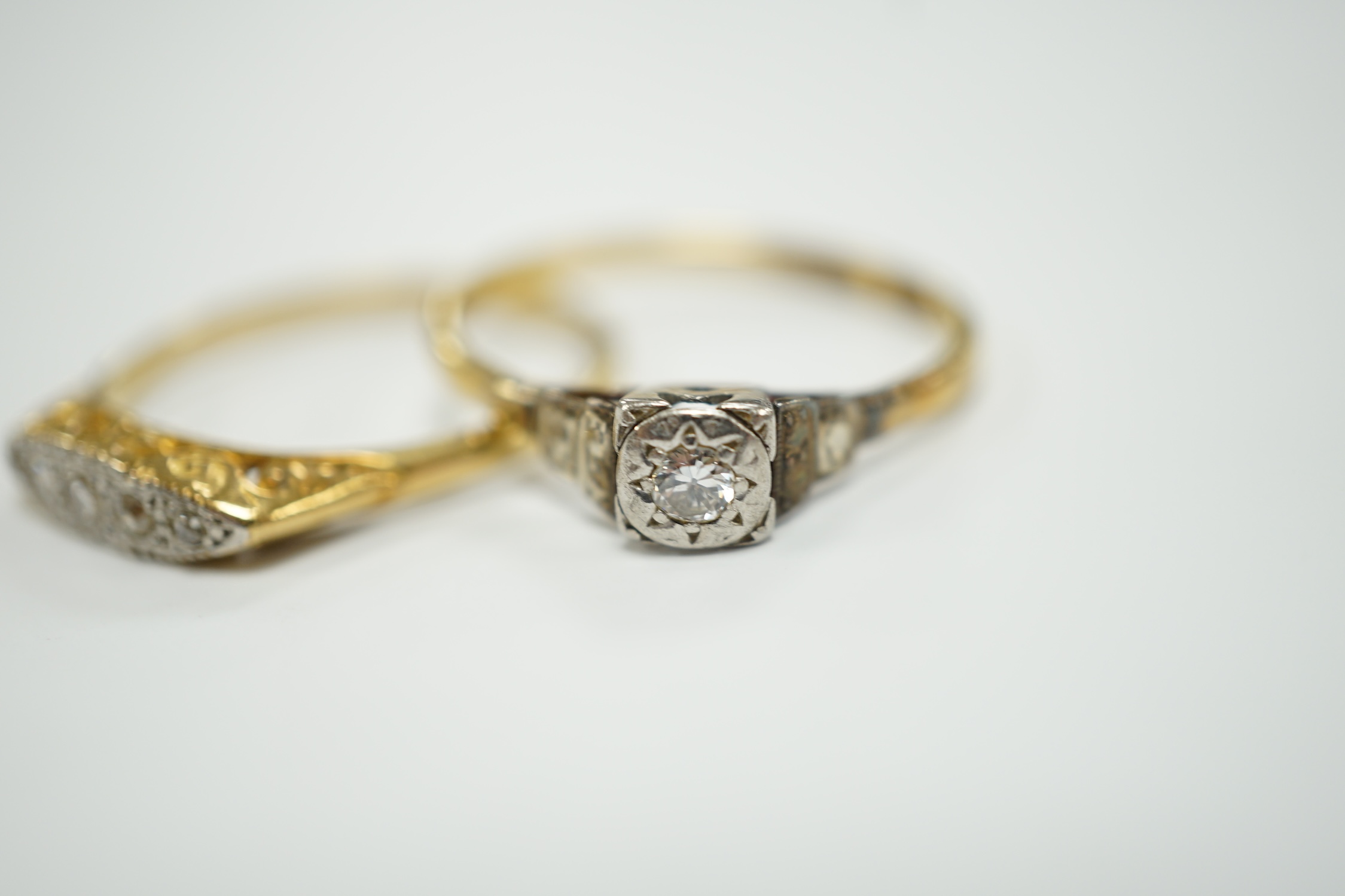 Two early to mid 20th century 18ct, plat and diamond set rings, including graduated five stone, gross weight 7.8 grams.